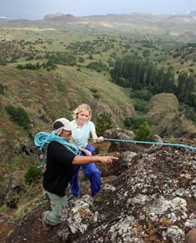 Stedson and Olivia hanging from a rock looking for the rare fern plants